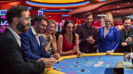 Glamorous Casino Gamlers Placing Bets and Having Fun while Winning at the Baccarat. Wealthy Casino...