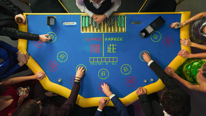 Top Down View Of Glamorous Casino Gamblers Placing Bets and Having Fun While Winning at Baccarat...