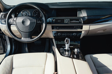 Interior of a business-class car, white perforated leather, aluminum, black lacquer, interior details.