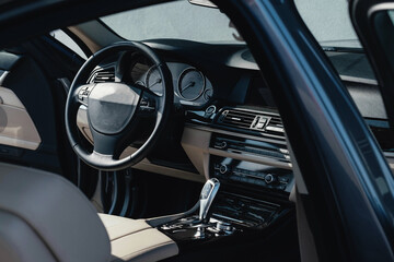 Interior of a business-class car, white perforated leather, aluminum, black lacquer, interior details.