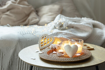 Home composition for Valentine's Day with candles in the interior of the room.
