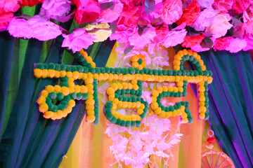 Mehndi hindi text with decorative flowers at mehendi function in india