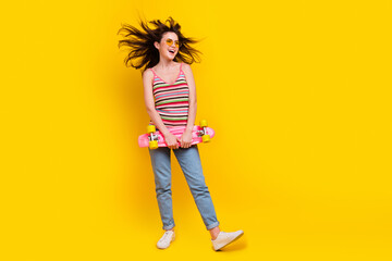 Full size photo of overjoyed woman dressed knitwear top hold skateboard look at promo empty space...