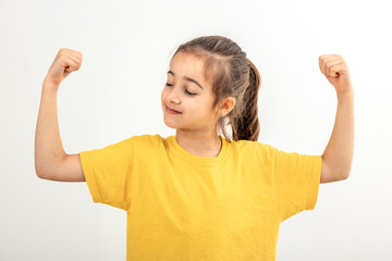 Funny girl hand flexing demonstrating biceps isolated on white background.