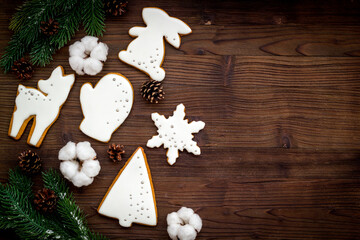 White Christmas cookies with fir tree branches, top view. New Year decoration