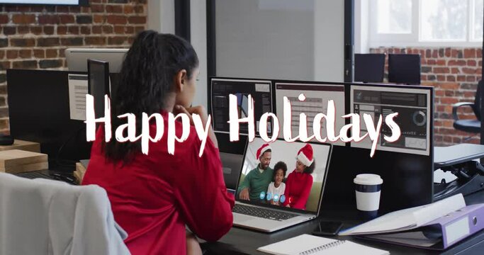 Animation of happy holidays text over african american family on laptop screen at christmas