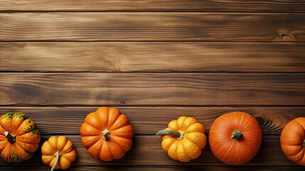 A group of pumpkins on a orange color wood boards