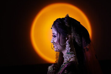 Side portrait of indian bride on yellow light