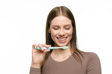 Young beautiful woman with toothbrush isolated on white background