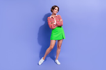 Fototapeta na wymiar Full length photo of cool adorable pretty girl wear stylish shirt green skirt standing arms crossed isolated on blue color background