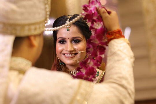Beautiful indian bride doing garland ritual or varmala at wedding