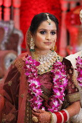 Beautiful indian bride at wedding wearing makeup and jewellery