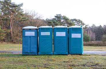 Four mobile toilets on a row