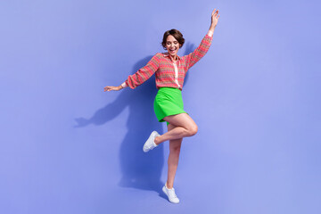 Full length photo of good mood gorgeous funny girl wear stylish shirt green skirt dancing having fun isolated on blue color background