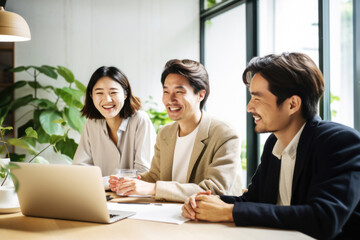 Group of asian business people sitting around a table together. Teamwork concept