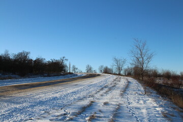Fototapeta na wymiar A road with snow on the side