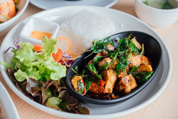 Stir-Fried Crispy Pork with Thai Basil is a popular Thai dish that is made with crispy pork belly, 