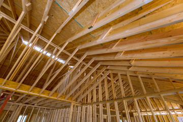Construction of new home is unfinished, including beams stick trusses, as well as roofing framing