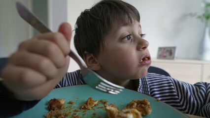 Child talking with mouth full of food during lunch time