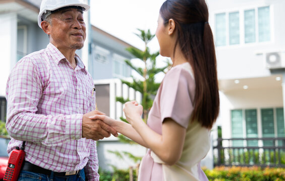 Happy homeowner stand in front of contractor and shake hand, handyman holding clipboard and after checking details before renovations home, house improvement interior, Interior design