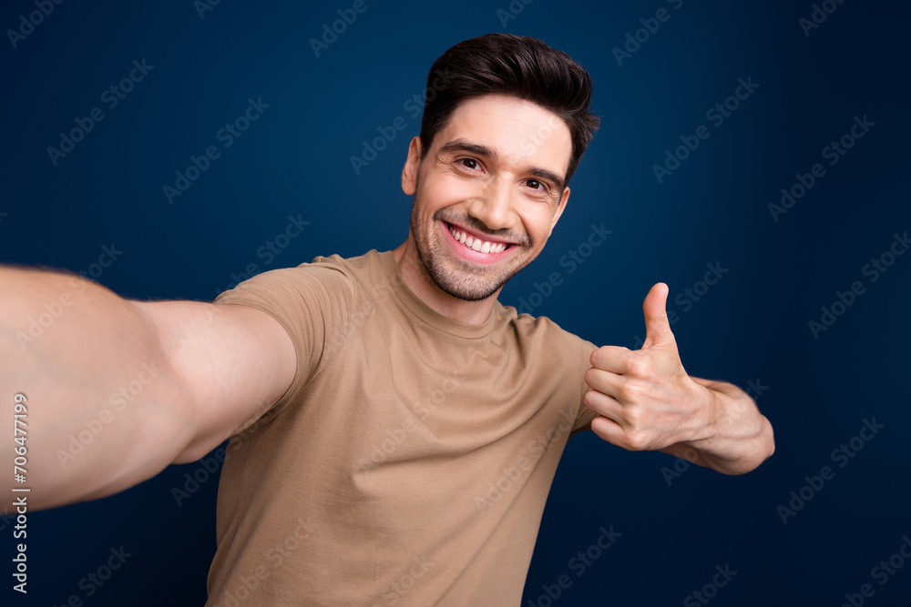 Sticker Photo of attractive man wear stylish beige clothes live stream video thumb up nice feedback isolated on dark blue color background