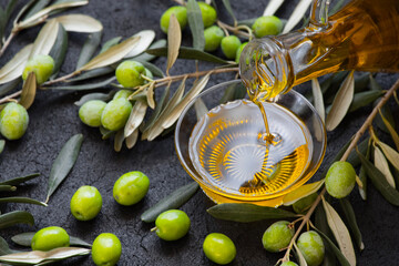 Image of raw green olives and liquid olive oil