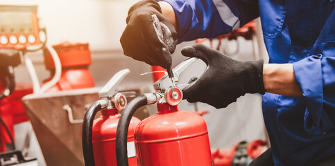 Engineer check fire suppression system,check fire extinguisher tank in the fire control room for safety - obrazy, fototapety, plakaty