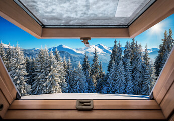 Beautiful winter mountains trough roof window