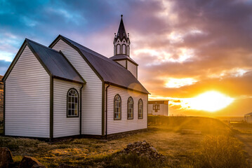 Typical rural Icelandic Church at sea coastline on sunset - obrazy, fototapety, plakaty