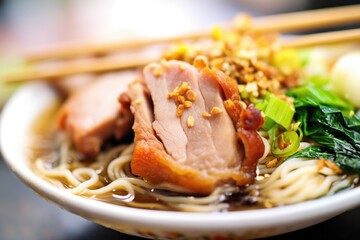 close-up of ramen noodles with sliced pork on top