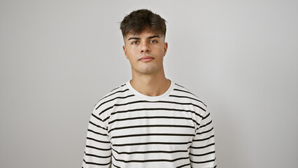 Young hispanic man standing with serious expression over isolated white background