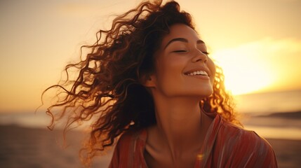 Gleeful Latina lady unwinding on shore at dusk with eyes shut. Lovely biracial woman savoring breeze through her hair. Enchanting lady inhaling crisp summer air by the beach. - obrazy, fototapety, plakaty
