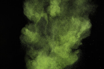 Light green powder explosion on black background. Citron color cloud. Lime dust explode. Freeze motion paint  Holi.
