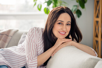 Portrait of adorable positive person beaming smile sit sofa spend pastime chilling modern bright...
