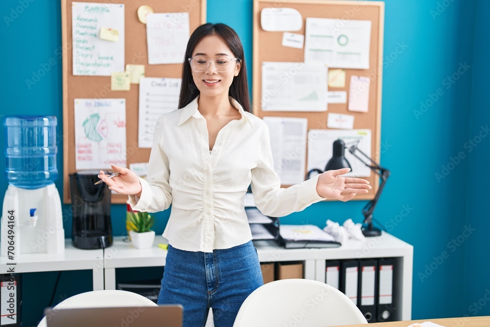 Canvas Prints Young chinese woman business worker speaking at office