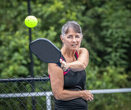Athletic pickleball player with eye on the ball.