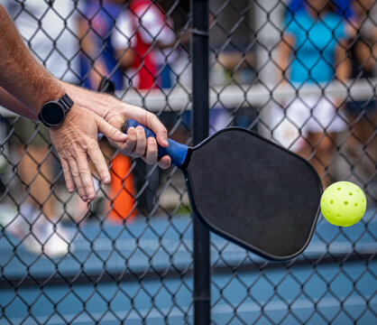 Extreme close up of pickelball paddle and ball