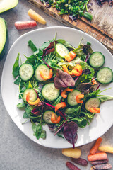 Vegetable salad in a plate on the kitchen table, top view.