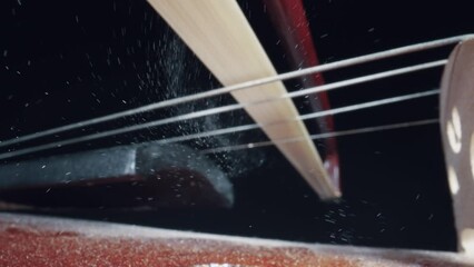 Concert of the symphony orchestra close-up of the bow on the violin, the concept of the development of musical taste classical music playing stringed classical musical instruments