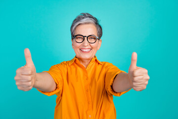 Portrait of optimistic grandmother show double thumbs up welcome in our team quality approvement...