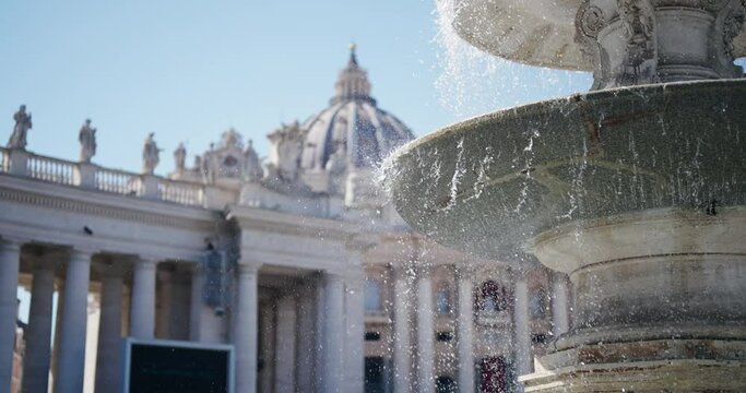 Cinematic view of foiuntain with colonnade of San Pietro. Vatican Rome, water flowing and spray in slow motion