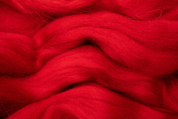 Red merino wool for felting as background.