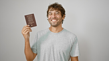 Joyful young man confidently flashing his czech republic passport, smiling widely against an...
