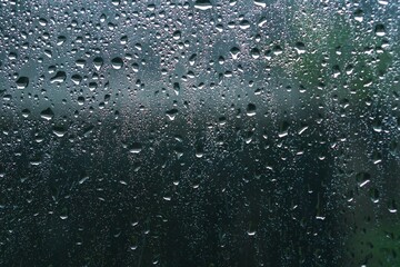 rainy days rain drops on the window surface. Background and textutre of wet window with rainy drops