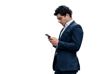 A business man in a suit uses a phone to write a message. The manager in the office is an employee...
