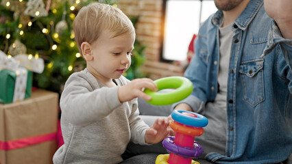 Father and son celebrating christmas playing with toys at home