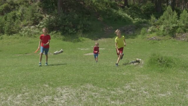 Happy boys runing in mountain river bank on a Sunny summer day. Slow motion. Children playing Outside by the river.
The concept of friendship, peace, kindness, childhood.