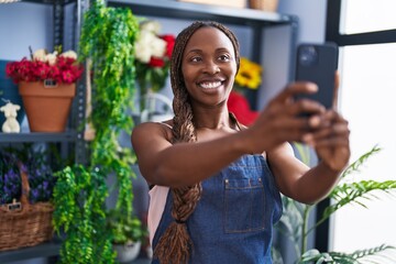 African american woman florist make selfie by smartphone at flower shop