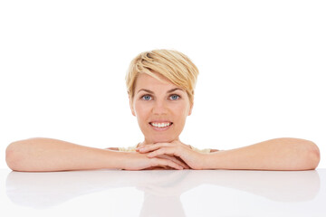 Fototapeta premium Happy woman, portrait and relax with hands on table isolated on a white studio background. Face of young female person, model or blonde smile in confidence with hairstyle for beauty on mockup space