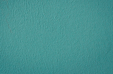old plastered wall surface for rough textured background or wallpaper of bright blue color, close-up